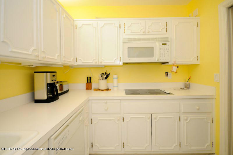 2195 Ibis Isle Road, Unit 6 Palm Beach, FL 33480 - Photo 10 of 15 a kitchen with stainless steel appliances granite countertop a sink and cabinets