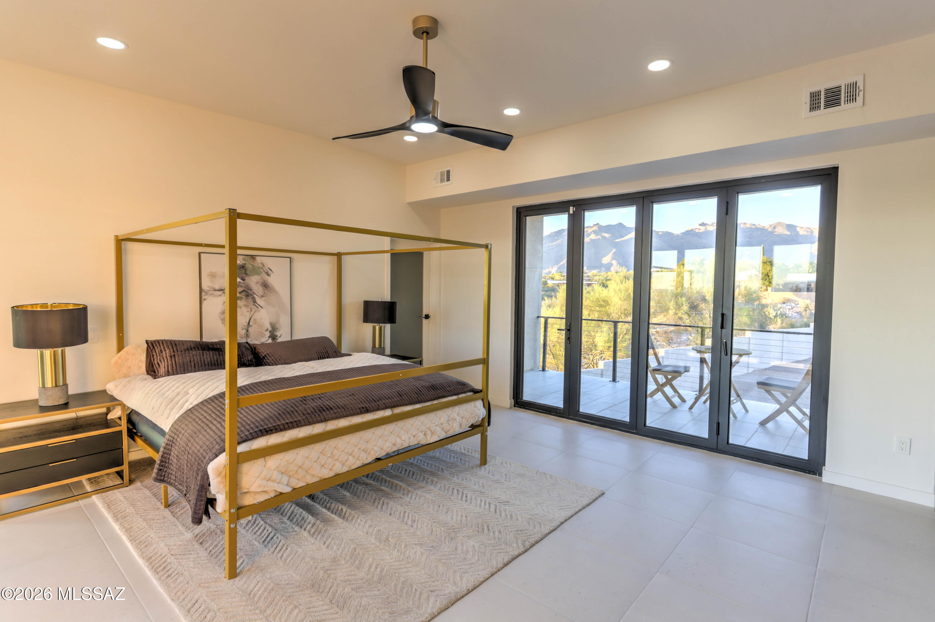 4939 East River Road Tucson, AZ 85718 - Photo 15 of 29 a spacious bedroom with a large bed and a large window