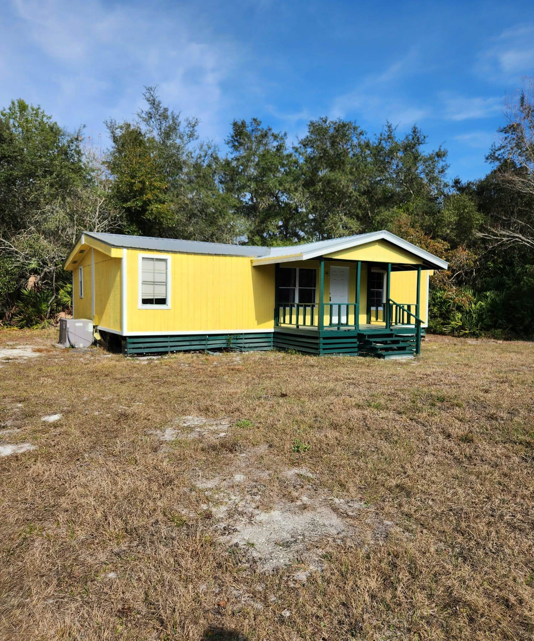 View of front of house with a front lawn and covered porch