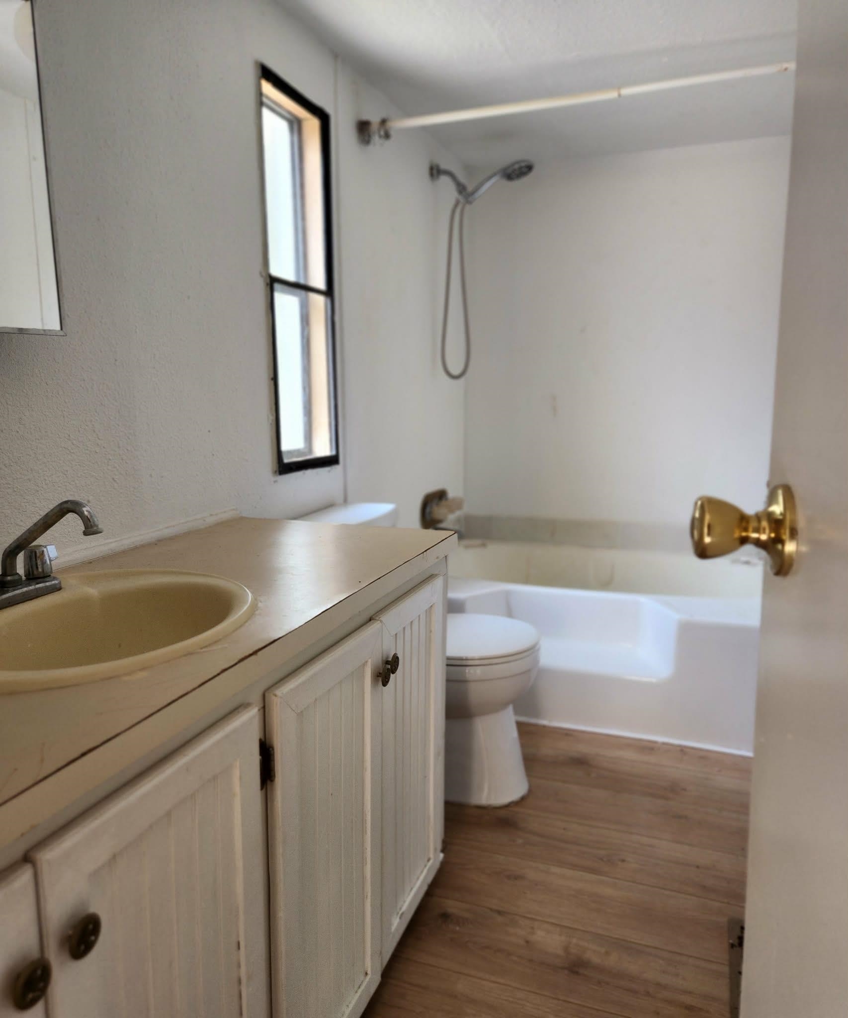 890 Poinsettia Road, Unit B St. Augustine, FL 32086 - Photo 11 of 14 Bathroom with vanity, dark wood-type flooring, bathtub / shower combination, and a textured wall