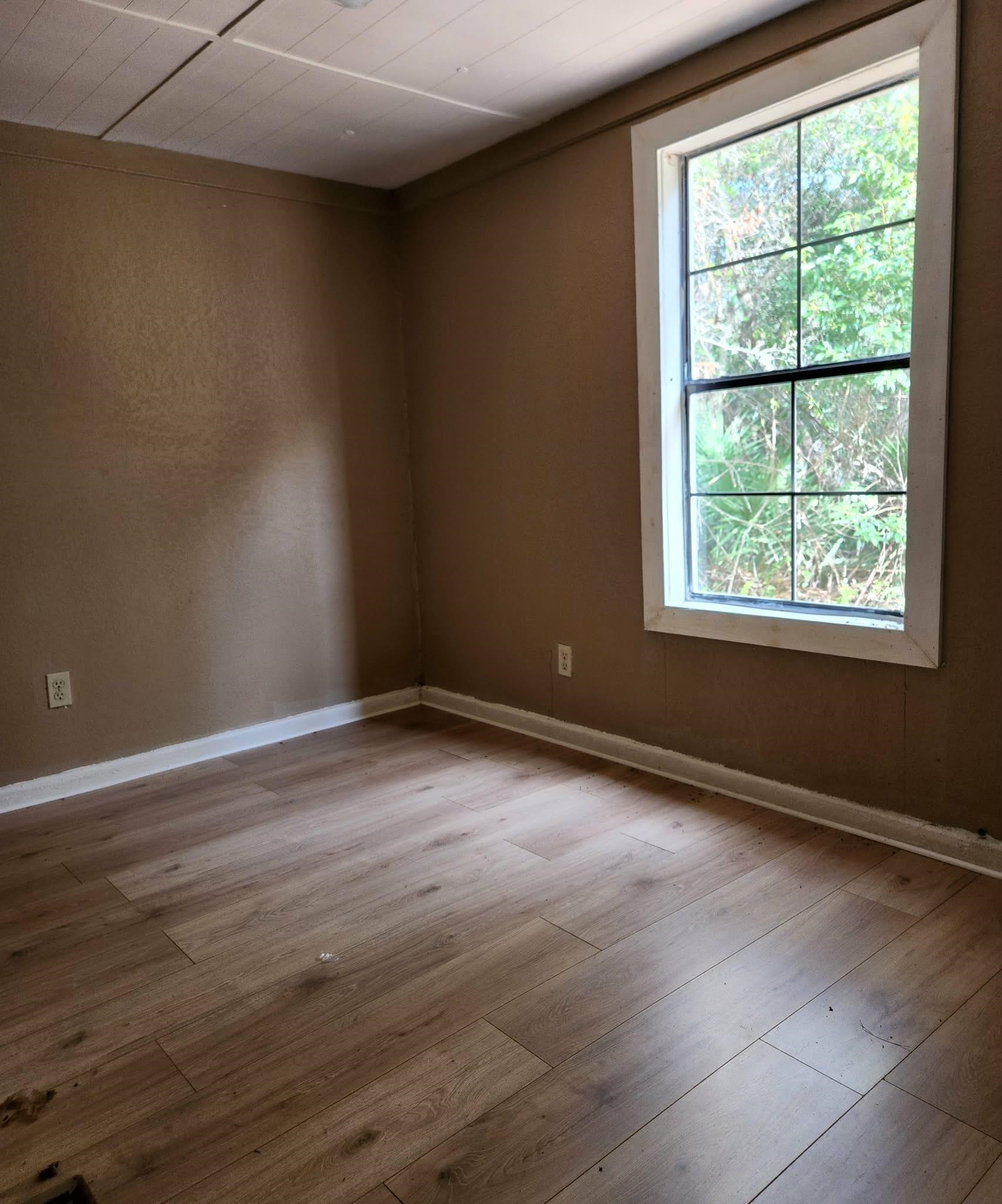 890 Poinsettia Road, Unit B St. Augustine, FL 32086 - Photo 12 of 14 Empty room with baseboards and light wood-style flooring