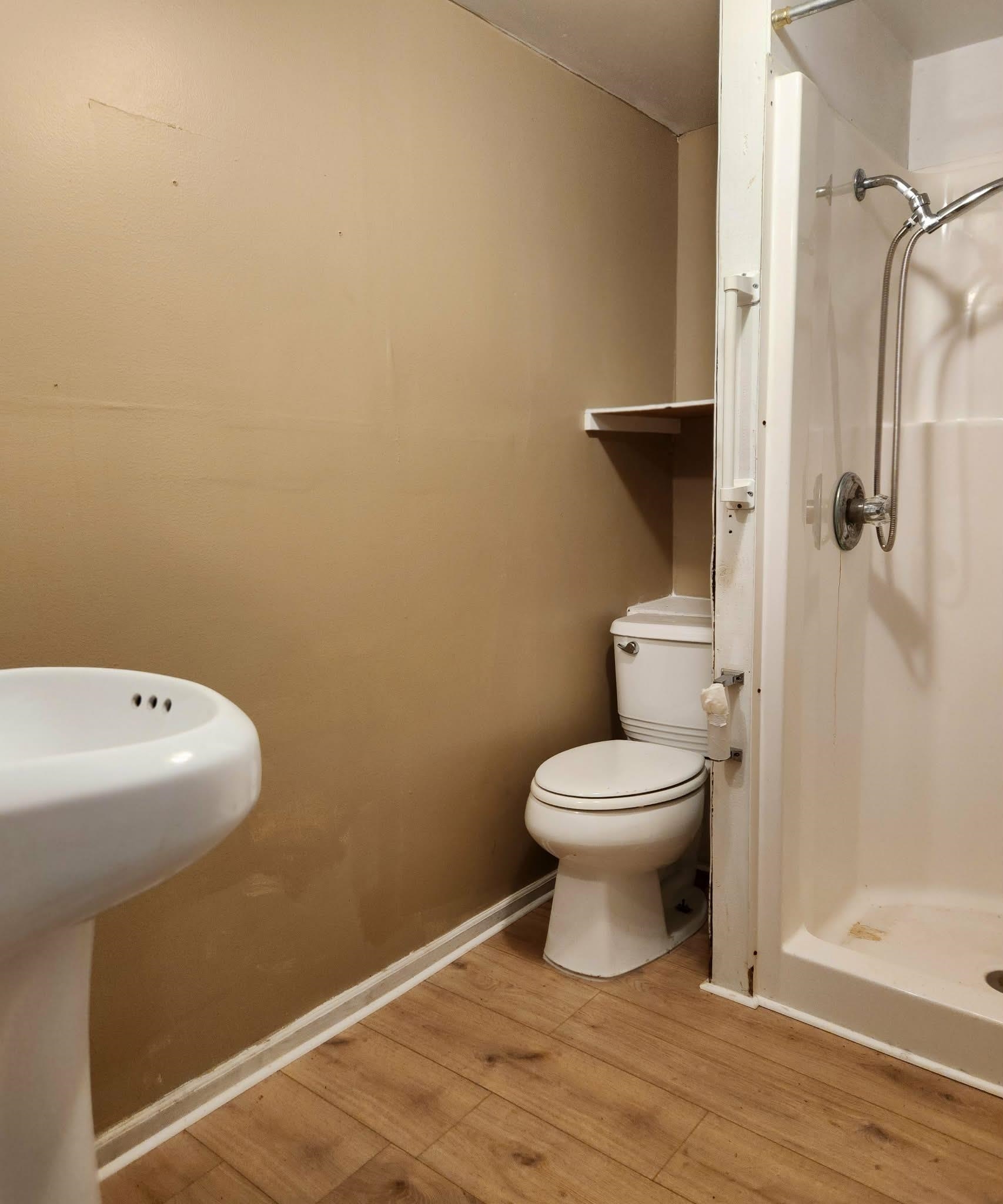890 Poinsettia Road, Unit B St. Augustine, FL 32086 - Photo 13 of 14 Bathroom featuring wood finished floors and a shower stall