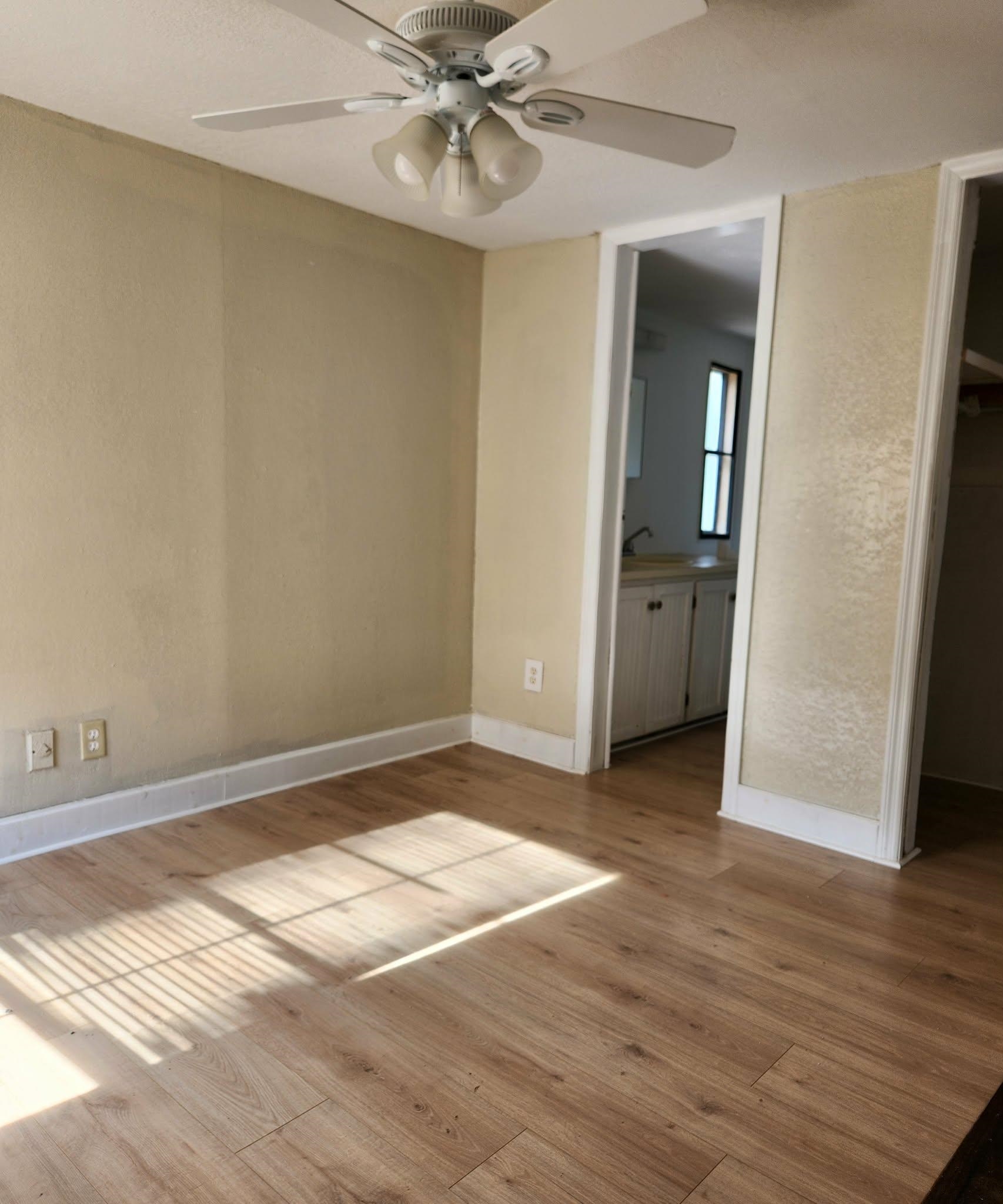 890 Poinsettia Road, Unit B St. Augustine, FL 32086 - Photo 10 of 14 Empty room with a ceiling fan and light wood-type flooring