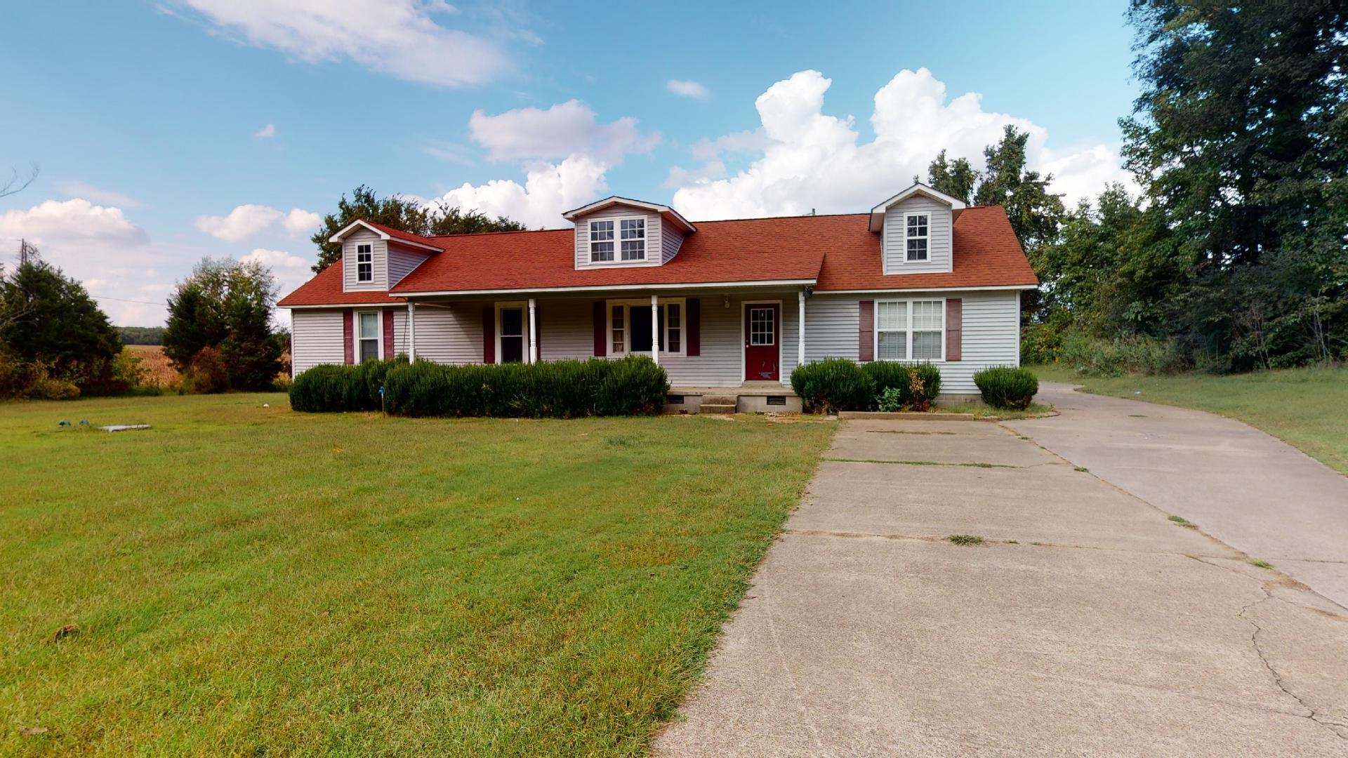 a front view of a house with a garden