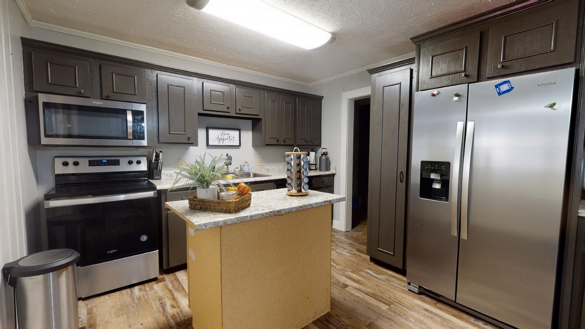 772 Cobb Road Newbern, TN 38059 - Photo 3 of 13 a kitchen with stainless steel appliances granite countertop a refrigerator and a stove top oven