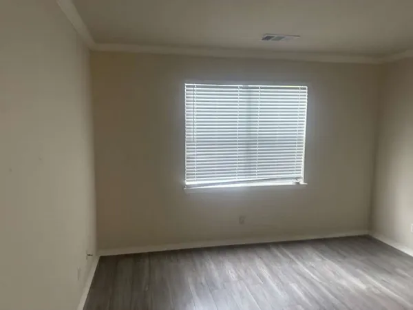 a bedroom with a bed and a lamp