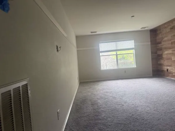 an empty room with wooden floor and closet