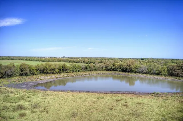 a view of a lake with houses in the back