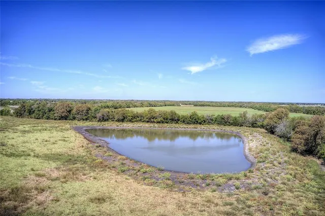 a view of a lake with a yard