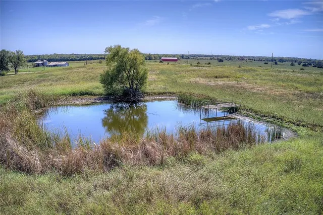 a view of a lake with a yard