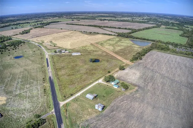 an aerial view of a residential houses with outdoor space