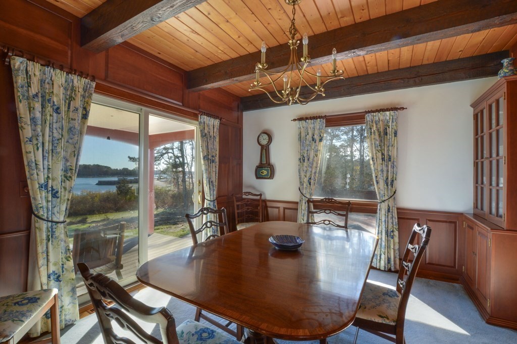 95 S Road Bourne, MA 02559 - Photo 12 of 33 a view of a dining room with furniture wooden floor and a chandelier