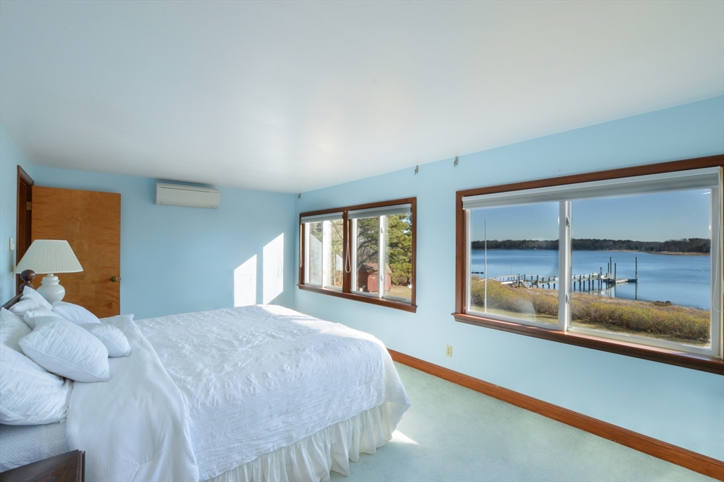 95 S Road Bourne, MA 02559 - Photo 14 of 33 a bedroom with a large bed and a large window