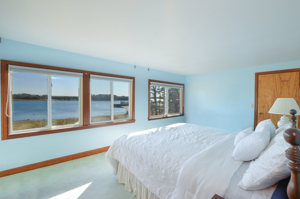 95 S Road Bourne, MA 02559 - Photo 15 of 33 a bedroom with a bed and a large window