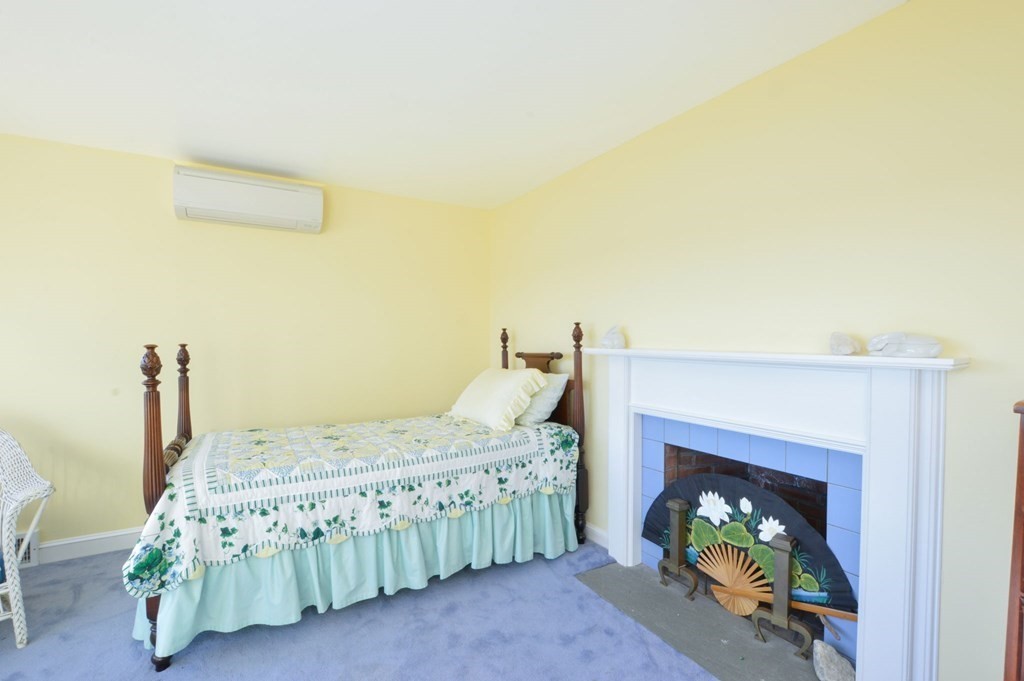 95 S Road Bourne, MA 02559 - Photo 18 of 33 a bedroom with a bed and a fireplace