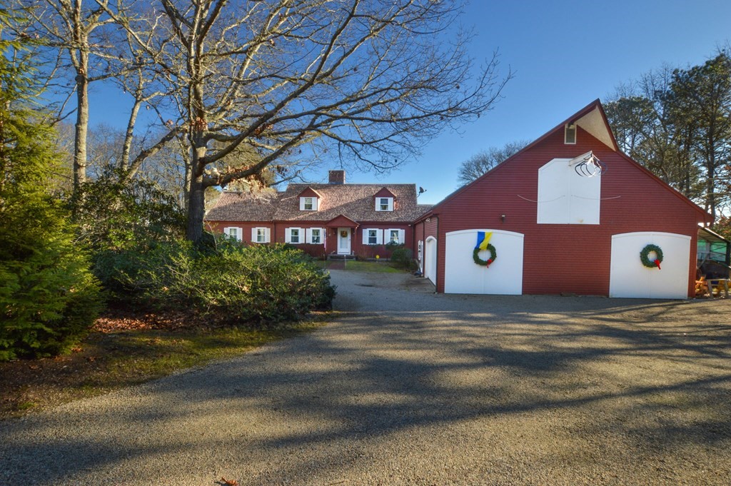 95 S Road Bourne, MA 02559 - Photo 4 of 33 a front view of a house with a yard