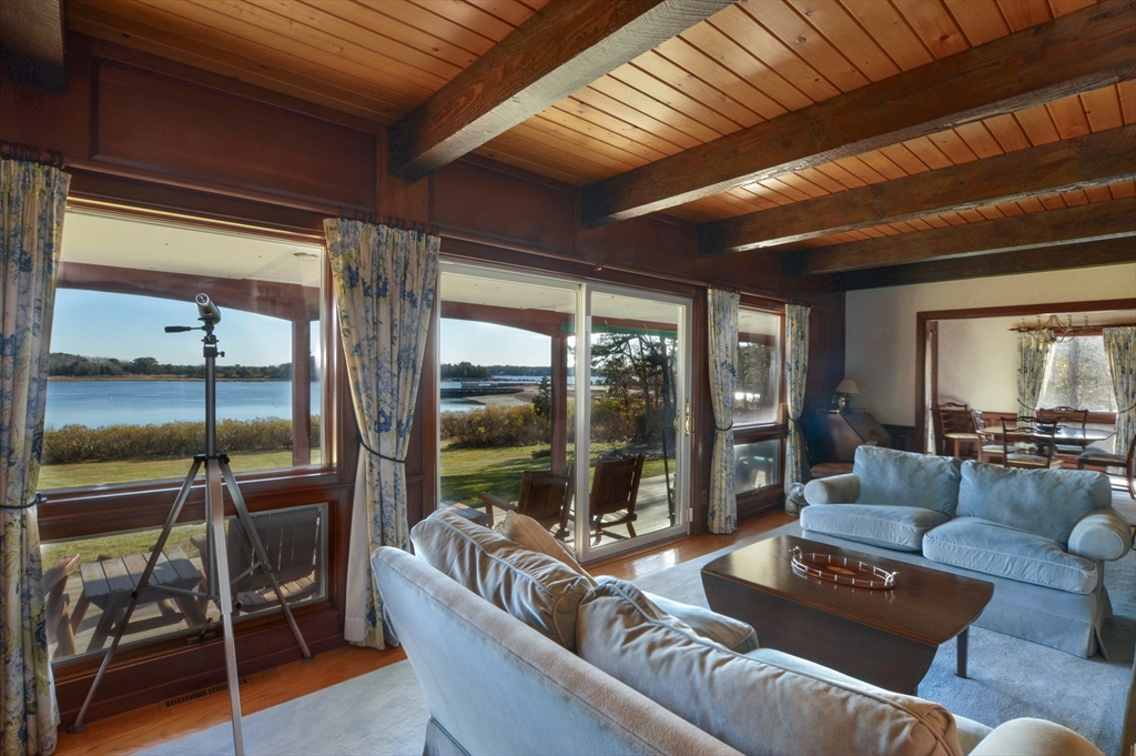 95 S Road Bourne, MA 02559 - Photo 7 of 33 a living room with furniture and a floor to ceiling window