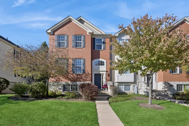 a front view of a house with a garden and plants