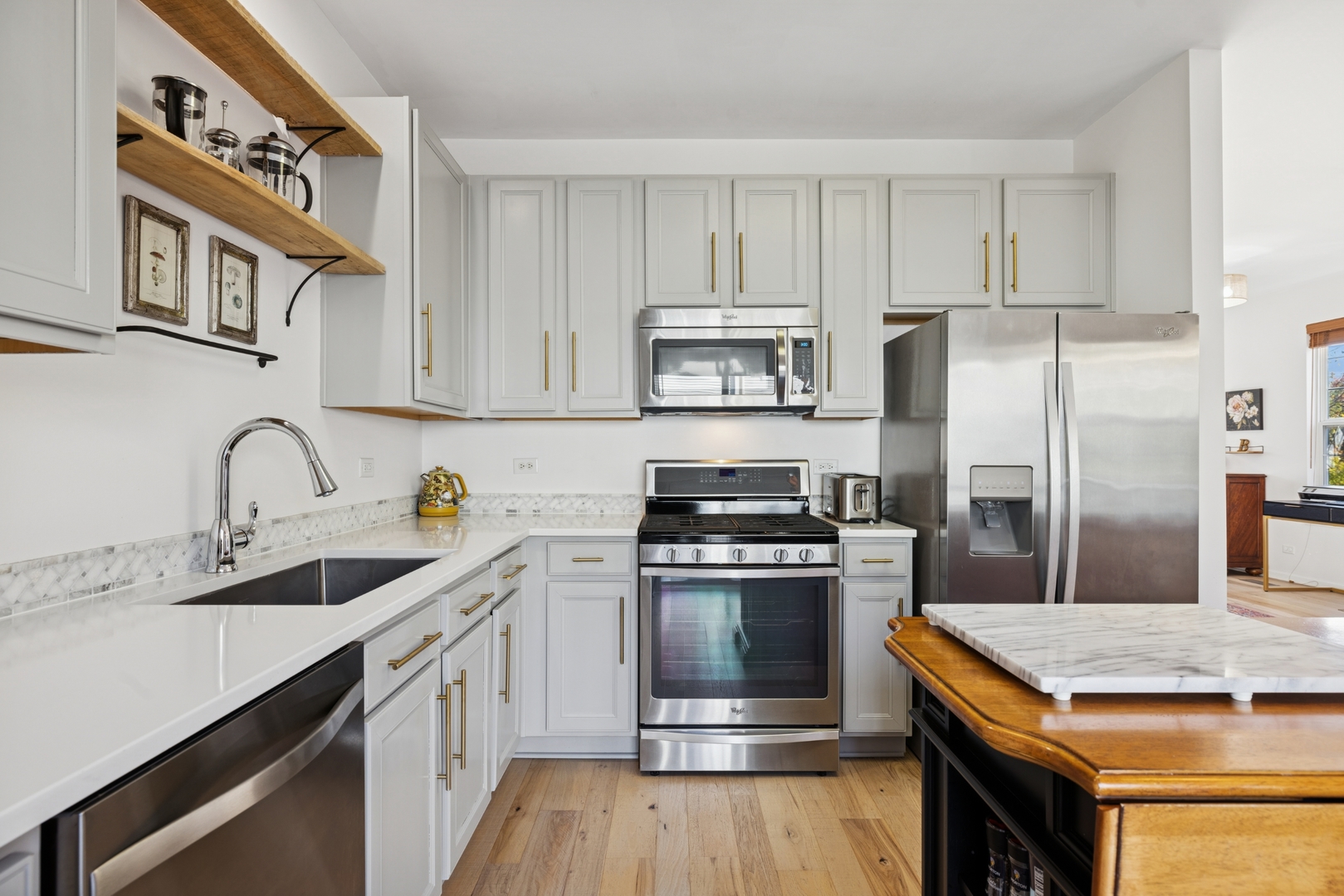 152 Jackson Street Gilberts, IL 60136 - Photo 11 of 31 a kitchen with stainless steel appliances granite countertop a kitchen island a stove a sink cabinets and a refrigerator