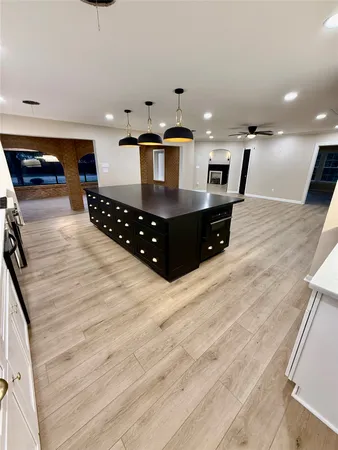 a kitchen with stainless steel appliances kitchen island granite countertop a sink counter space and cabinets