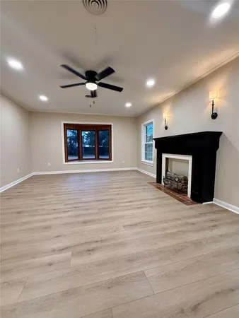 a kitchen with kitchen island granite countertop a sink dishwasher stove top oven and cabinets with wooden floor