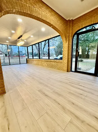 a view of a hall with wooden floors
