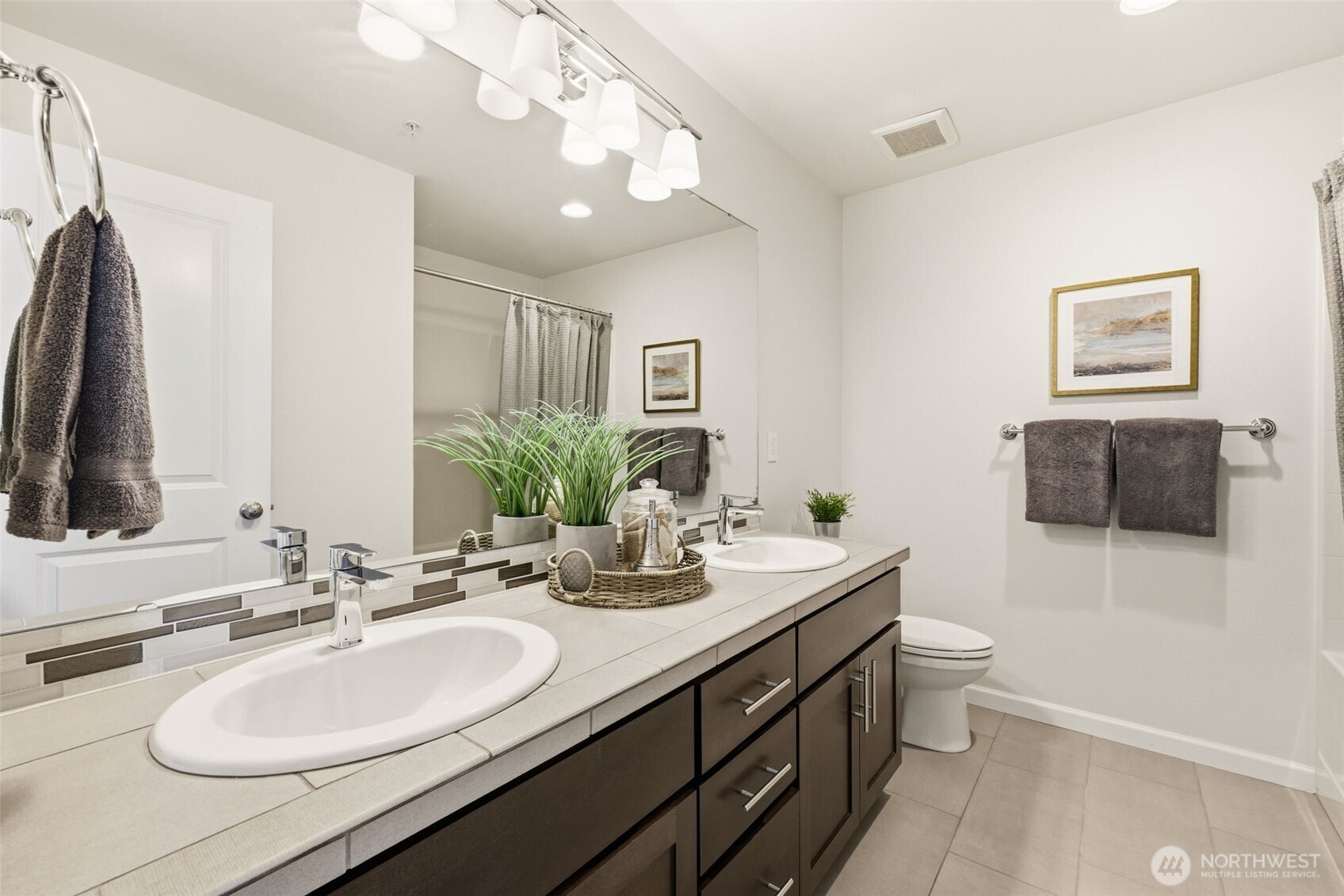 13125 83rd Lane South Seattle, WA 98178 - Photo 18 of 32 a bathroom with a double vanity sink and a mirror