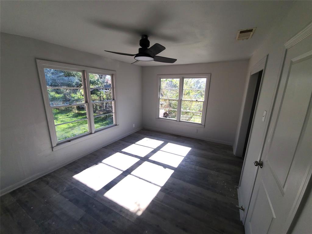 519 Dearborn Street Waco, TX 76704 - Photo 10 of 24 wooden floor in an empty room with a window