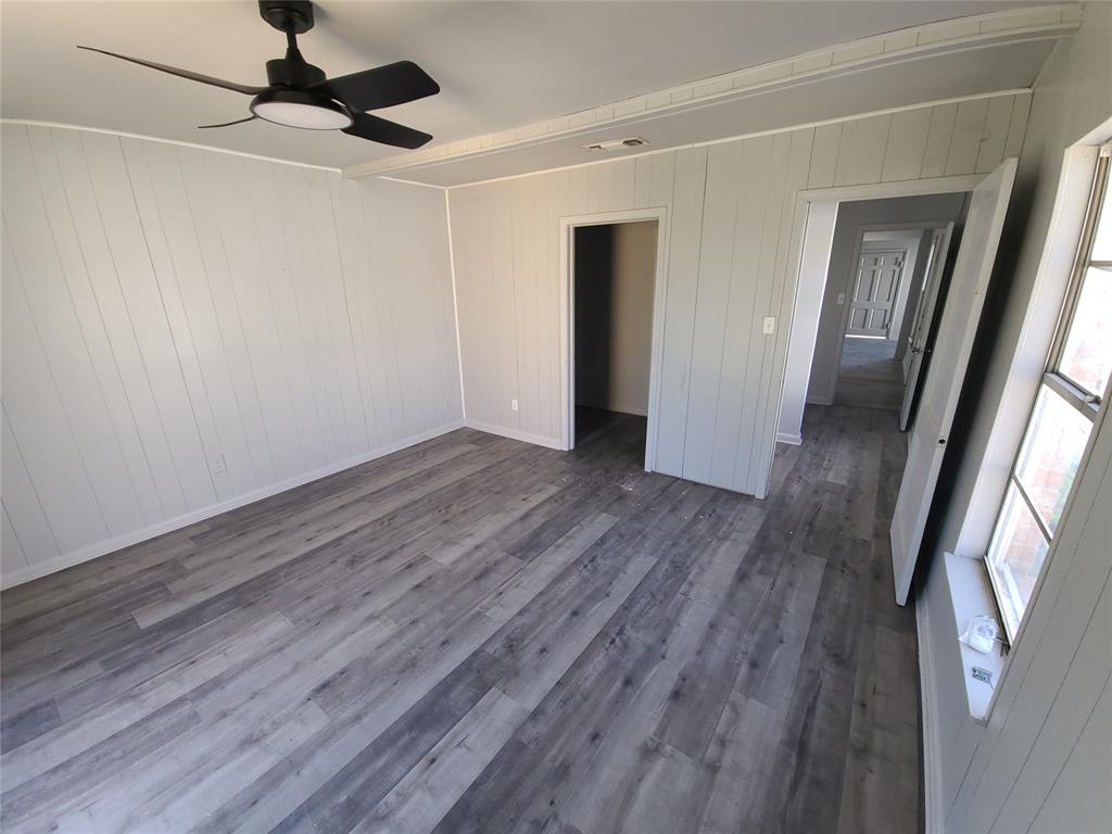519 Dearborn Street Waco, TX 76704 - Photo 18 of 24 a view of a livingroom with wooden floor and a ceiling fan