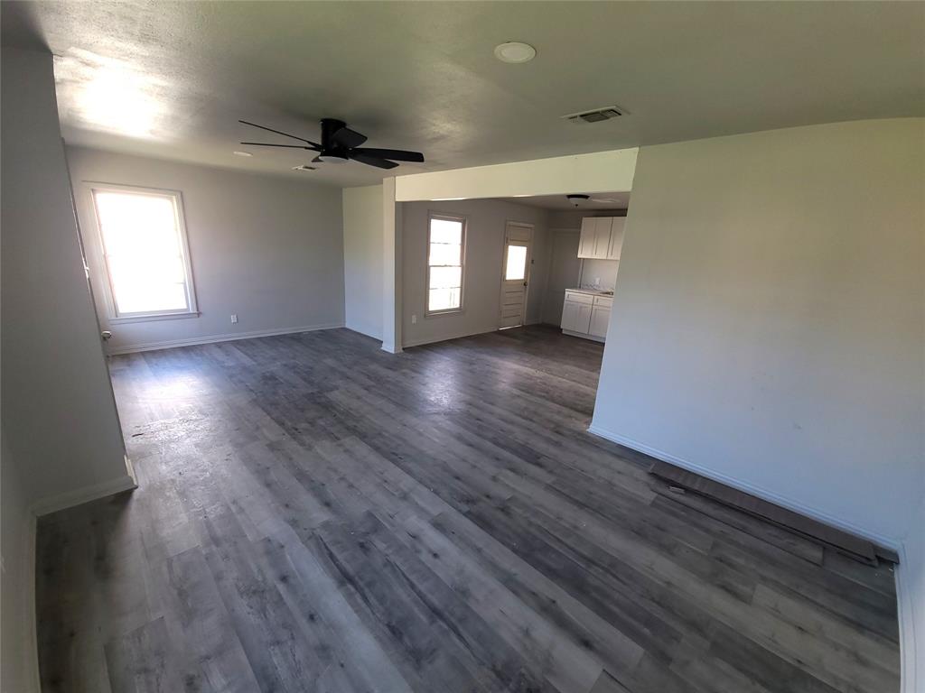 519 Dearborn Street Waco, TX 76704 - Photo 3 of 24 an empty room with wooden floor and windows