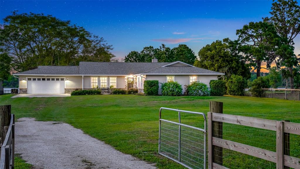a front view of a house with a yard table and chairs