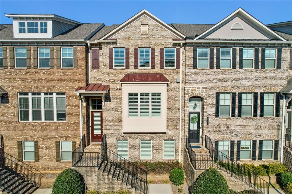 front view of a brick house with large windows