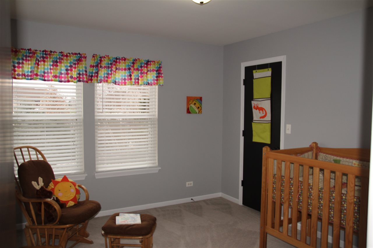 219 Ridgestone Trail Poplar Grove, IL 61065 - Photo 18 of 18 a room with furniture and a window