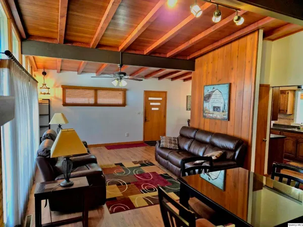 a view of a porch with a table and chairs