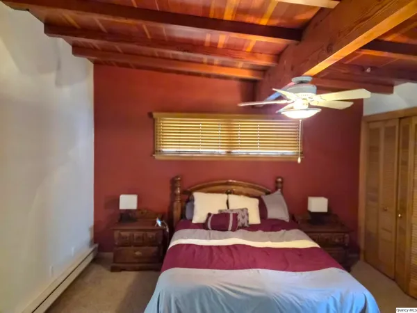 a bedroom with a bed and a mirror