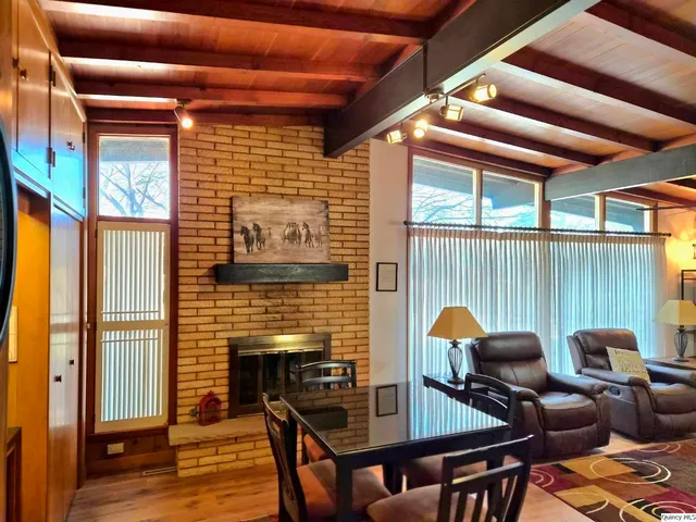 a dining room with furniture and wooden floor