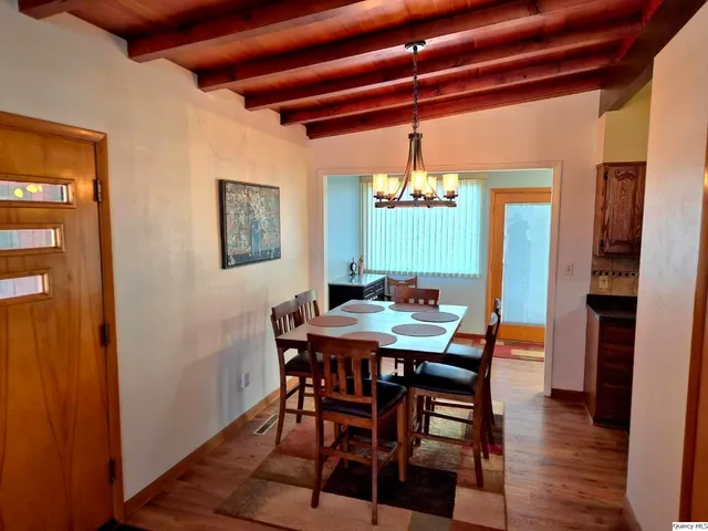 a kitchen with stainless steel appliances granite countertop a sink a stove and a wooden cabinets