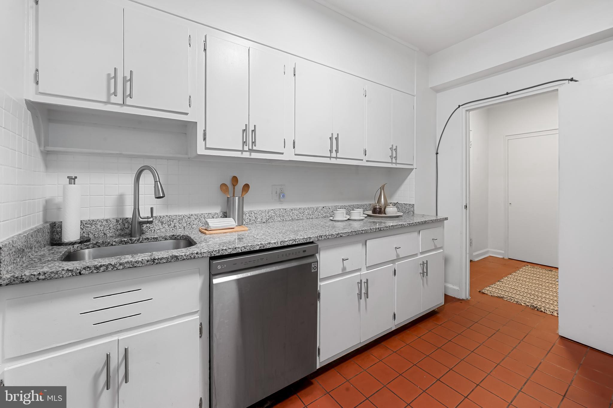 3601 Greenway, Unit 1 Baltimore, MD 21218 - Photo 15 of 29 a kitchen with granite countertop white cabinets and white appliances