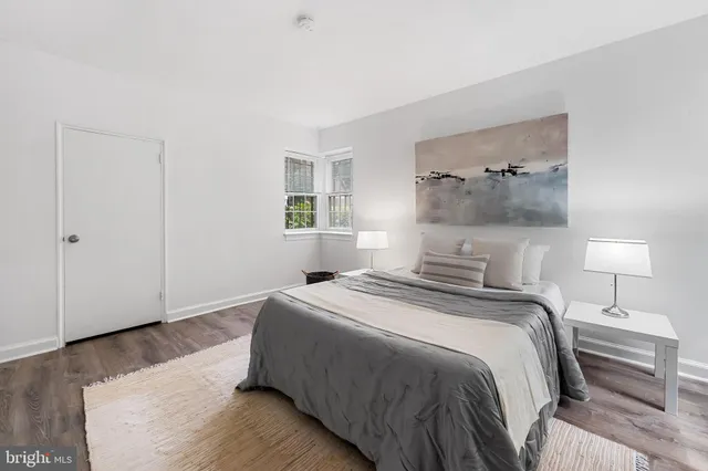 a bedroom with a bed and a night stand