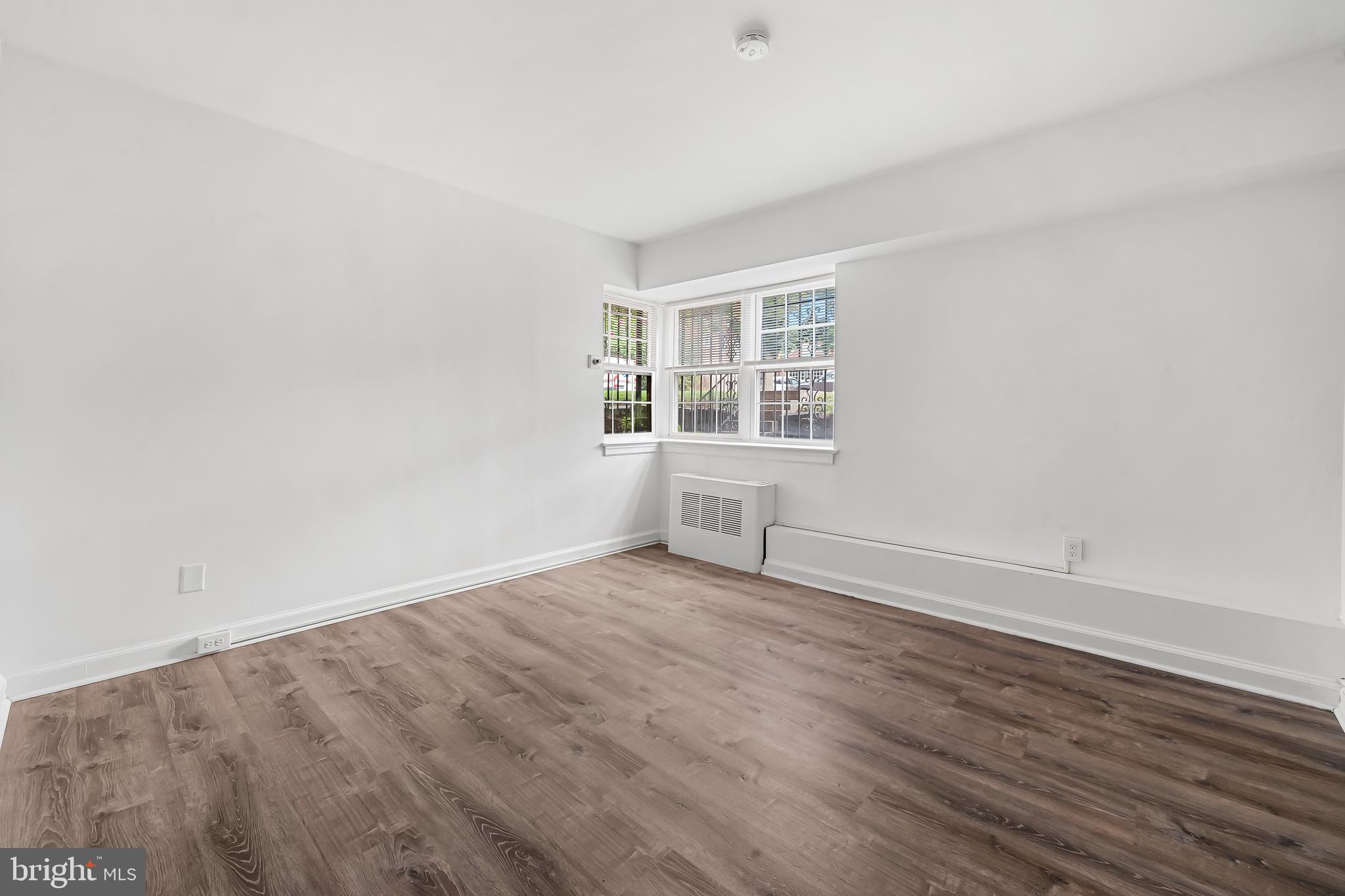3601 Greenway, Unit 1 Baltimore, MD 21218 - Photo 21 of 29 an empty room with wooden floor and windows