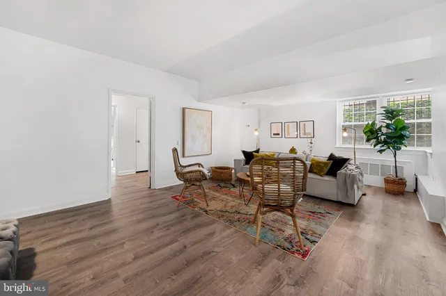 a living room with furniture and a wooden floor