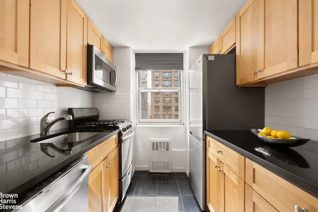 a kitchen with stainless steel appliances granite countertop a stove and a refrigerator