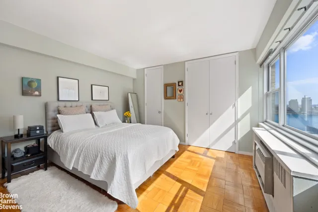 a spacious bedroom with a bed and a cabinets