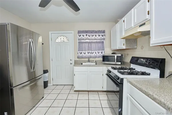a kitchen with a stove a refrigerator and a sink