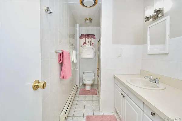 a bathroom with a sink mirror vanity and toilet