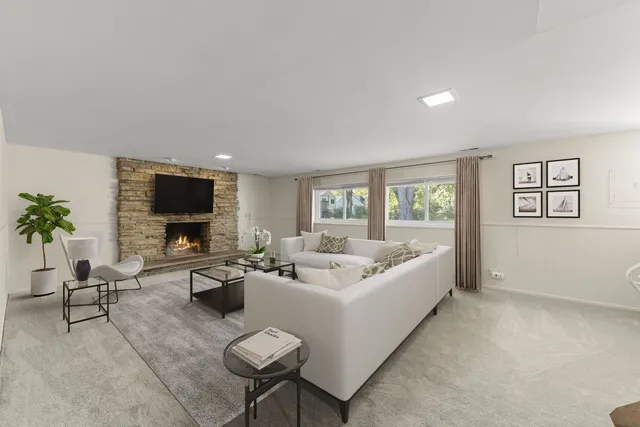 a living room with furniture a flat screen tv and large window