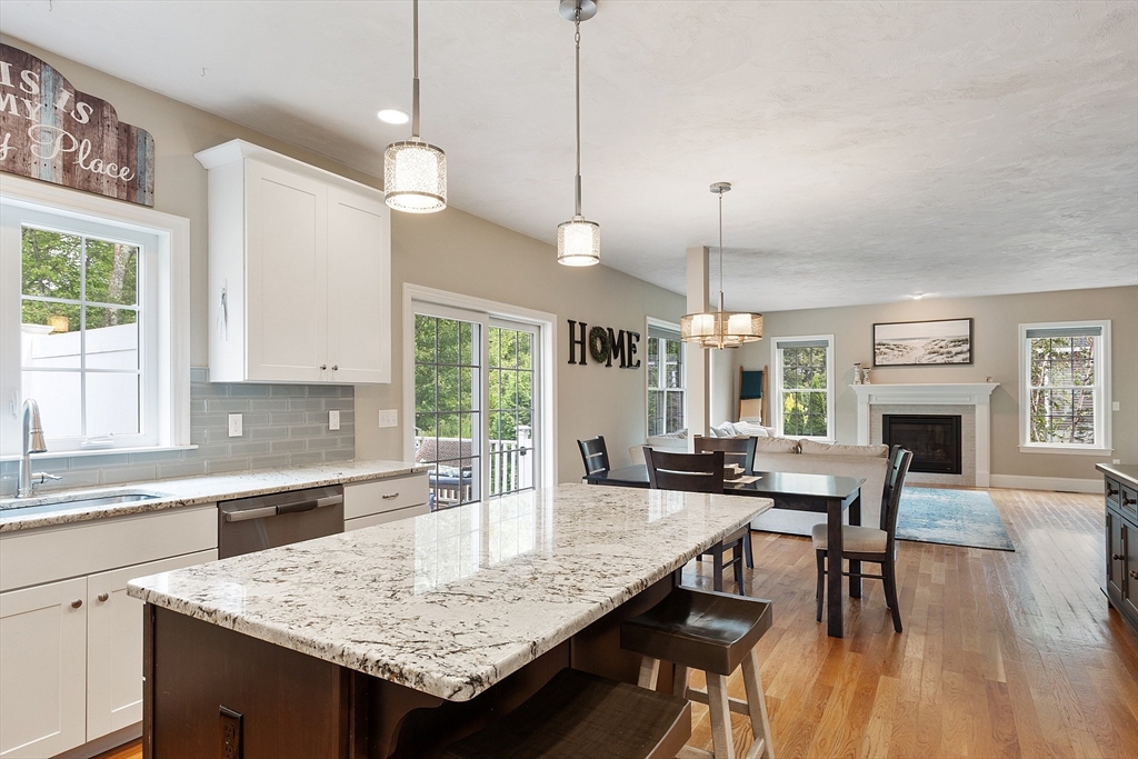 46 Jordan Road Holden, MA 01520 - Photo 10 of 42 a kitchen with granite countertop a stove a sink a dining table and chairs