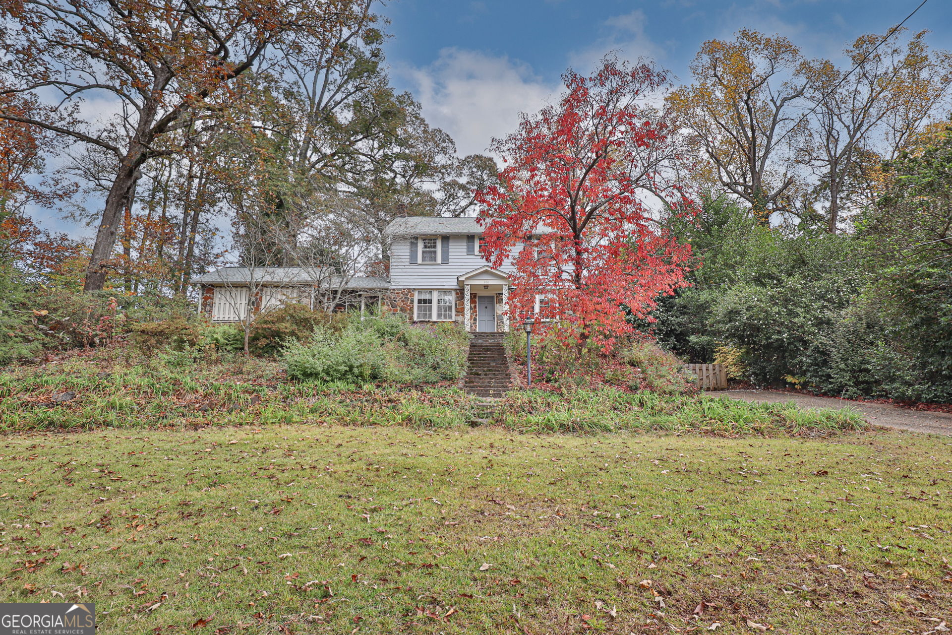 a yellow building in the middle of a yard
