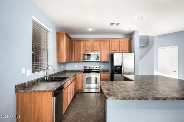 a white toilet sitting next to a bathroom sink