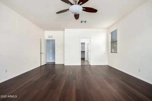 a view of a room with wooden floor and a window